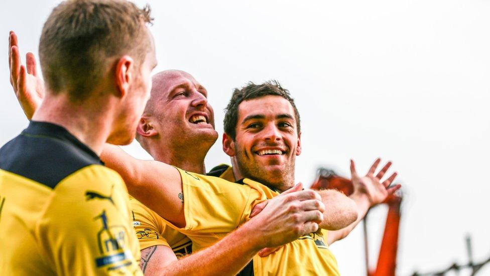 Cliftonville striker David McDaid is congratulated after scoring for the champions in their 3-1 away win over Linfield