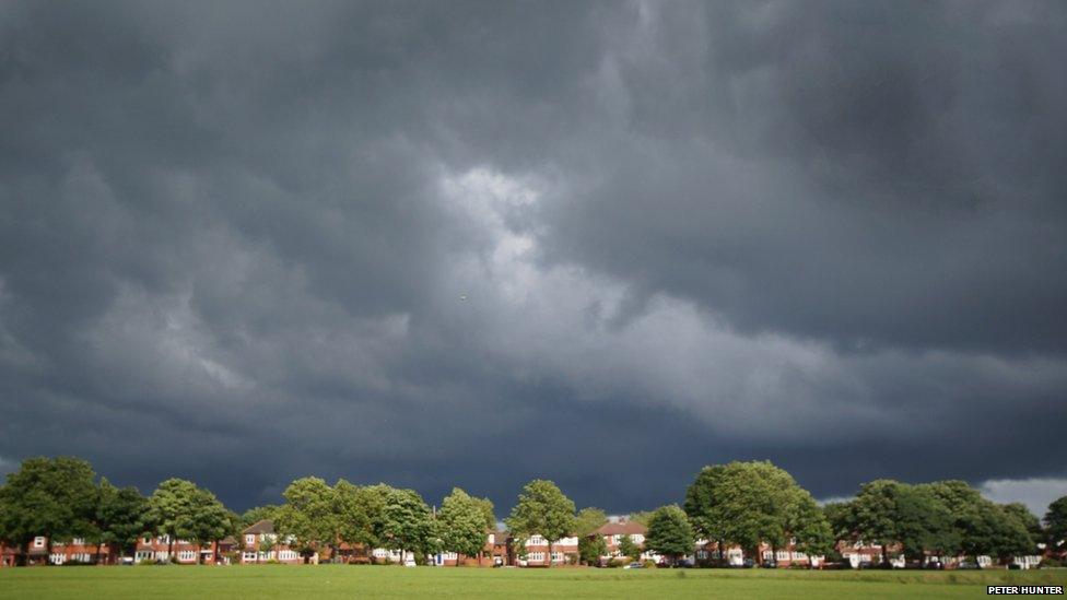 Grey skies hang over a row of houses.