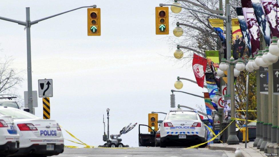 A bomb disposal robot rolls towards Parliament Hill following shootings in downtown Ottawa - 22 October 2014