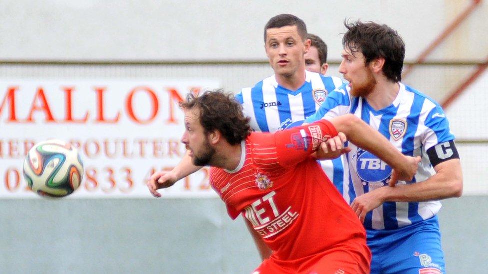 Portadown's Tim Mouncey attempts to shield the ball from Howard Beverland at Shamrock Park