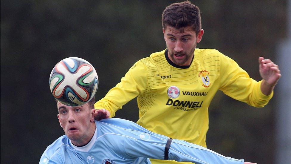 Institute's Paul McVeigh and Cameron Grieve of Dungannon keep their eyes on the ball