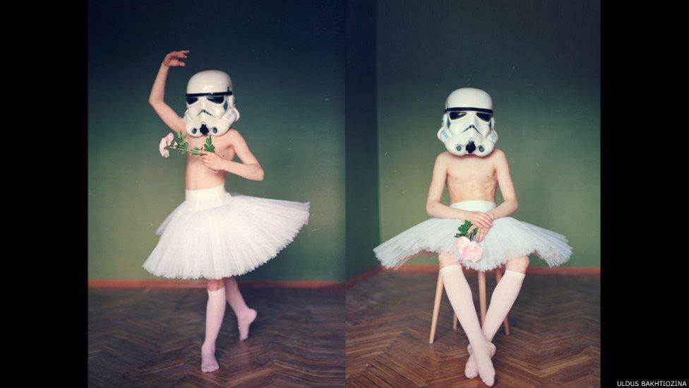 Boy with ballet skirt on and helmet