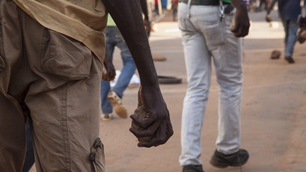 Protester with a stone in Ouagadougou (30 October 2014)