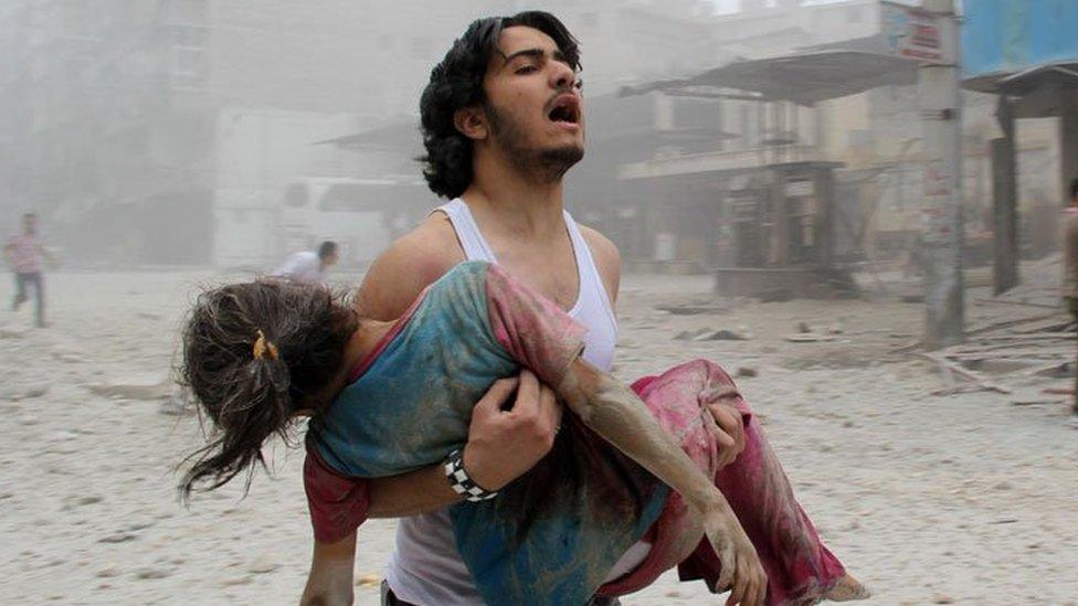 Grieving Syrian man and injued girl