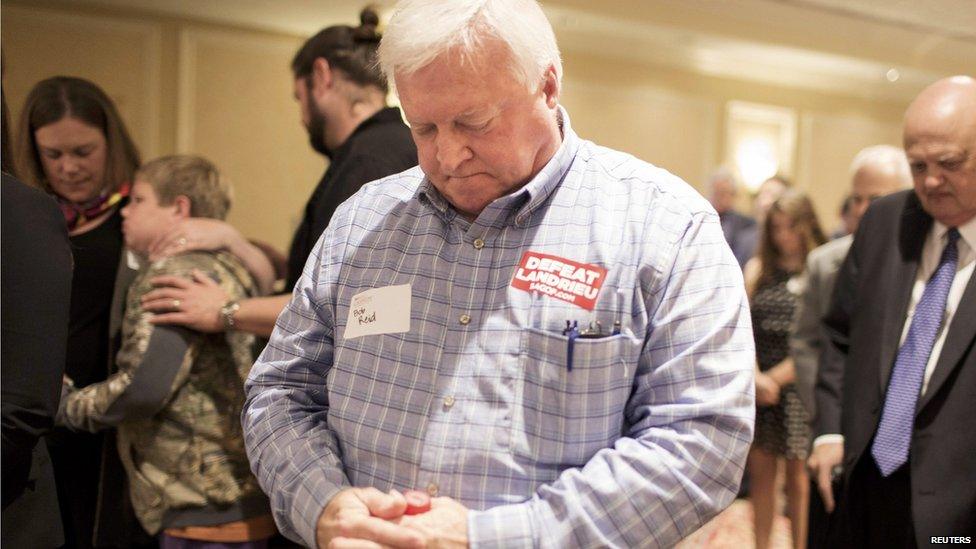 Supporter of US Senate candidate Republican Bill Cassidy bows his head during the invocation at Cassidy's election night gathering in Baton Rouge, Louisiana. 4 Nov 2014