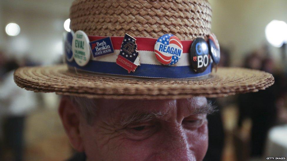 Hank Schwab of Atlanta shows the campaign hat he has worn for the past 30 years at a gathering in support of Republican US Senate candidate David Perdue at the InterContinental Buckhead Hotel, Atlanta. 4 Nov 2014