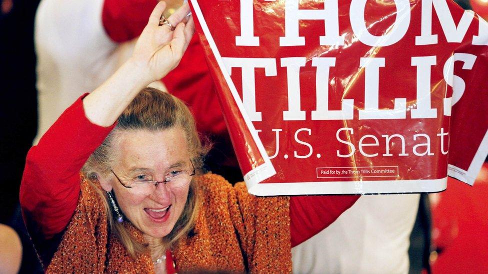Supporter of Republican candidate Thom Tillis cheers as results come in at rally in Charlotte, North Carolina
