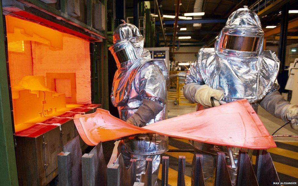 Technicians forming a fan blade for a jet engine from titanium alloys