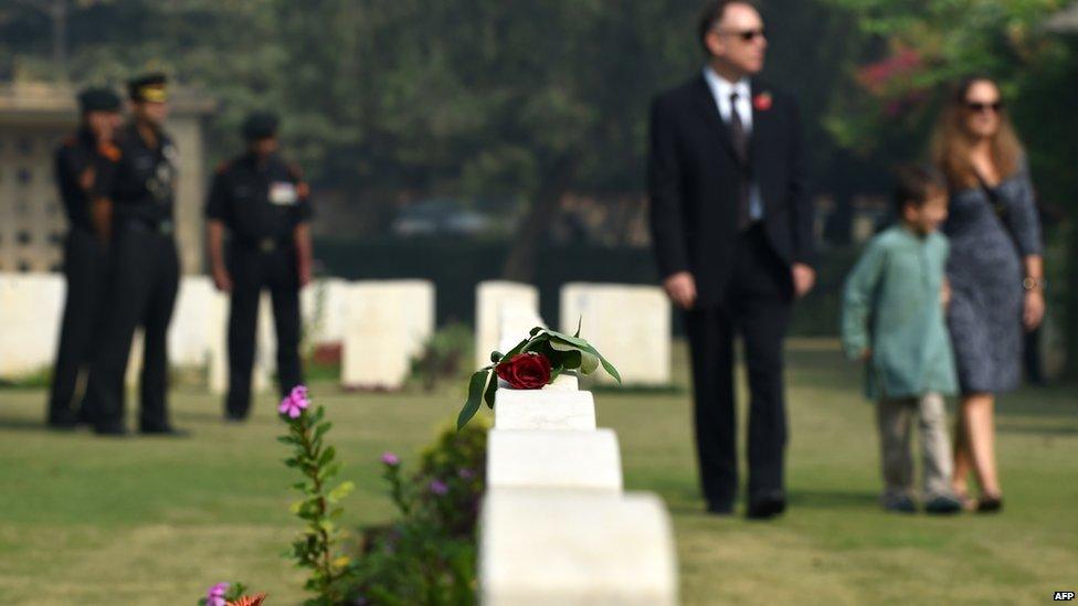 A rose lies on a tombstone at Delhi War Cemetery in New Delhi on November 9