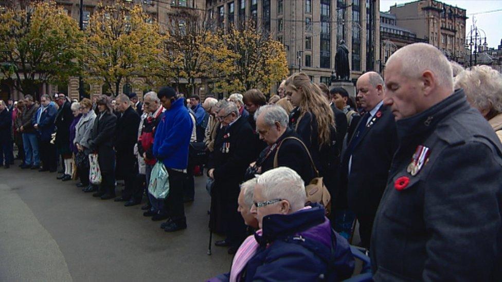 Crowd stands in silence