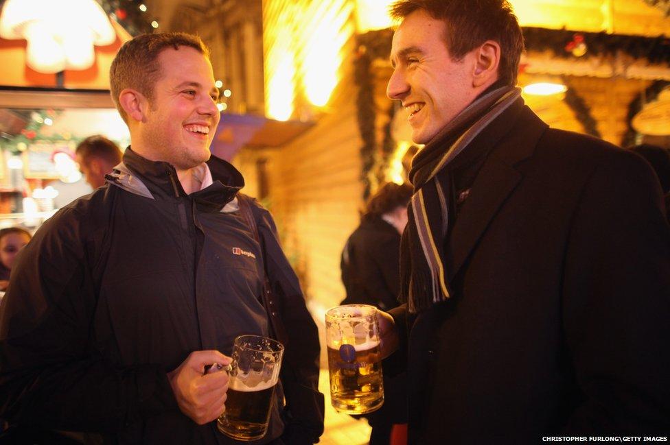 Christmas Market visitors enjoy a beer