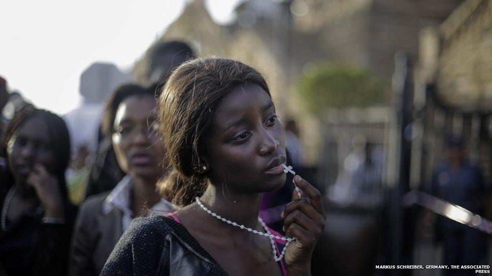 A woman reacts in disappointment after access to see former South Africa President Nelson Mandela was closed on the third and final day of his casket lying in state, outside Union Buildings in Pretoria, South Africa