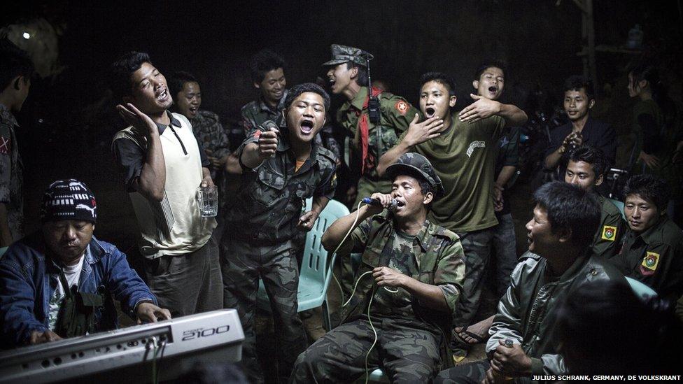 Kachin Independence Army fighters in Burma drinking and celebrating at a funeral of one of their commanders who died the day before