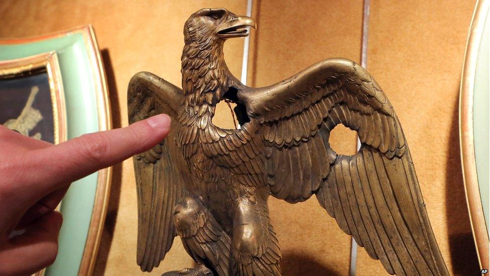 A damaged bronze flag eagle from the Napoleonic collection of the Palais de Monaco, is presented in Fontainebleau, south of Paris, France, Wednesday Nov. 12, 2014