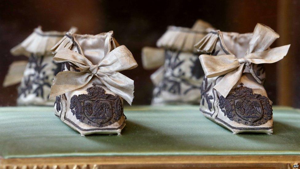 Christening slippers which belonged to the King of Rome (Napoleon Francois Charles Joseph), part of the royal family of Monaco's private Napoleonic collection, are displayed at the Osenat auction house in Paris, on October 28, 2014