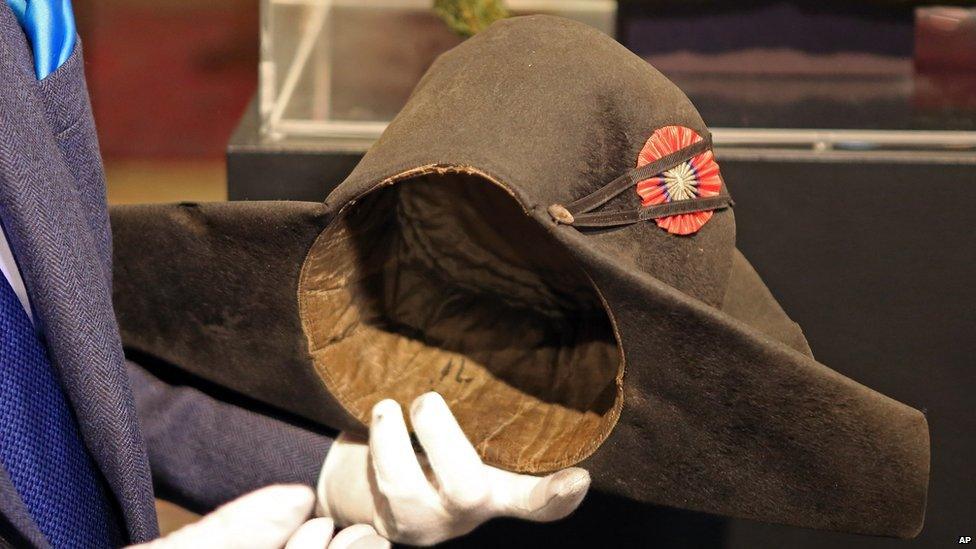 Napoleon expert Jean Claude Dey presents Napoleon's hat, from the Napoleonic collection of the Palais de Monaco, in Fontainebleau, south of Paris, France, Wednesday Nov. 12, 2014