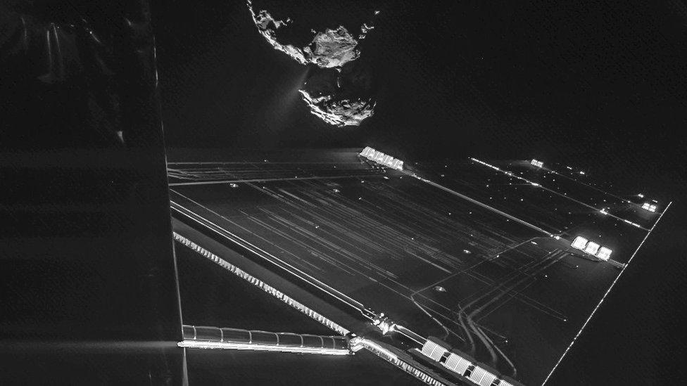 Rosetta spacecraft with the comet in the distance.