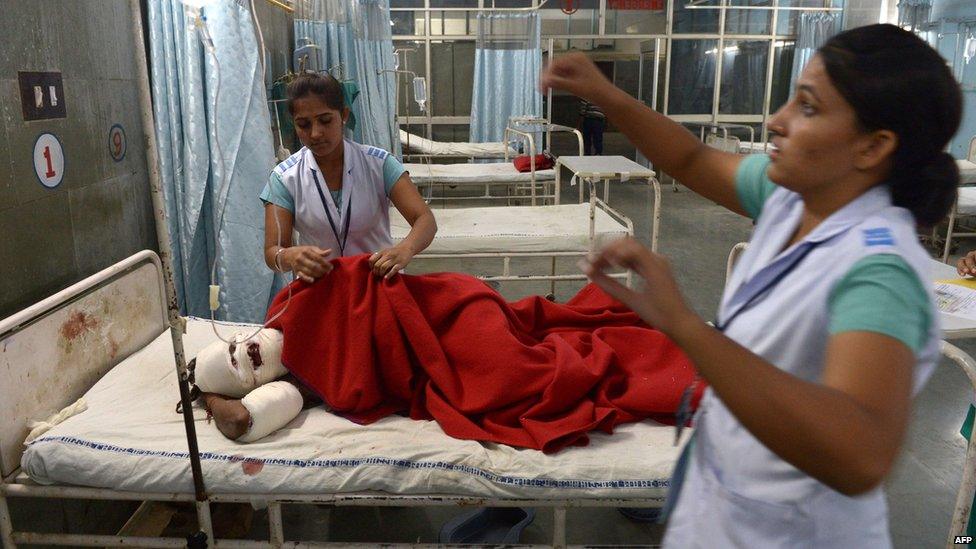 Indian nurses care for an injured supporter of "Godman" Rampal Maharaj at a hospital in Hisar, some 175 kilometres (108 miles) north of New Delhi on November 18, 2014