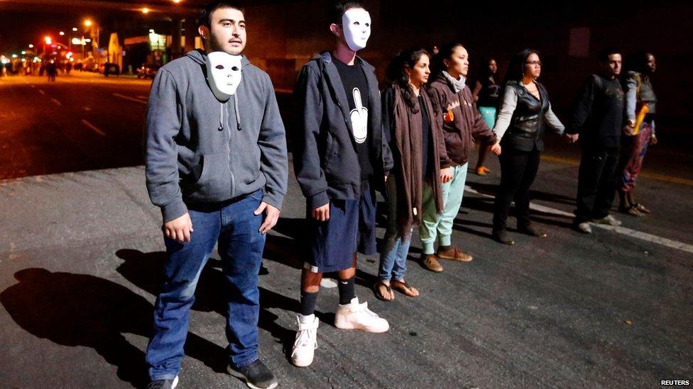 Protesters face off against police during a demonstration in Los Angeles, California, November 24, 2014,