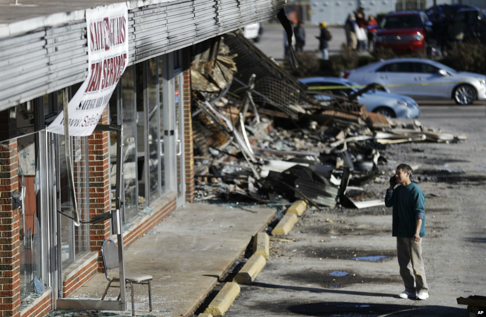 Shan Zhao, the owner of On On Chop Suey restaurant, inspects the damage to his business in Ferguson - 25 November 2014