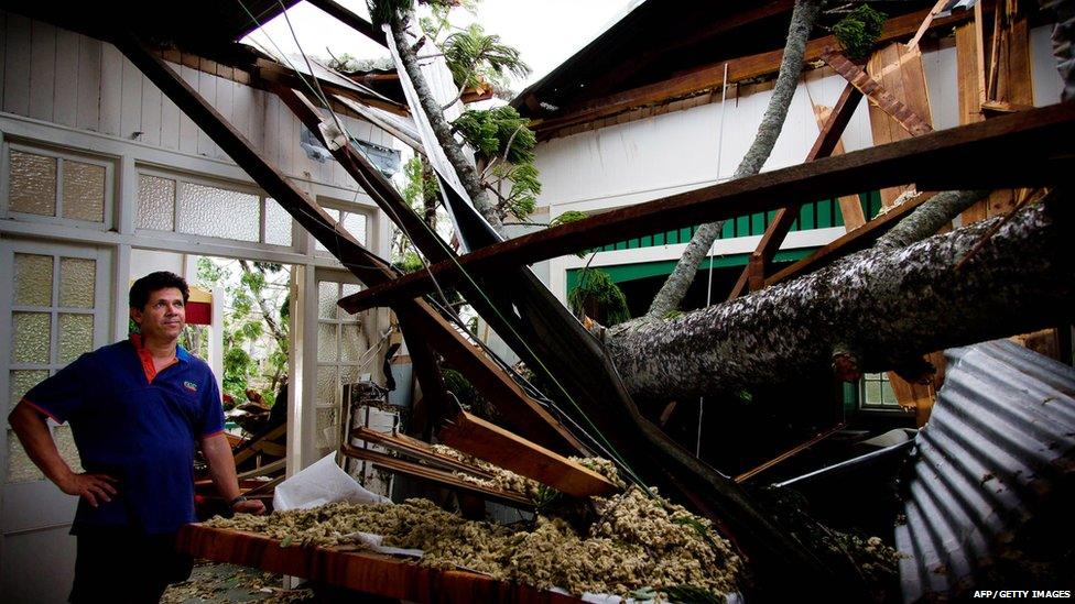 Man checks damage to his parents' home