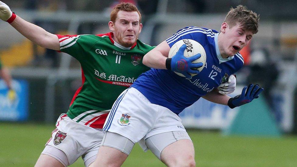 Inniskeen's Michael Lennon closes in on Warrenpoint opponent Aaron Magee at the Armagh Athletic Grounds