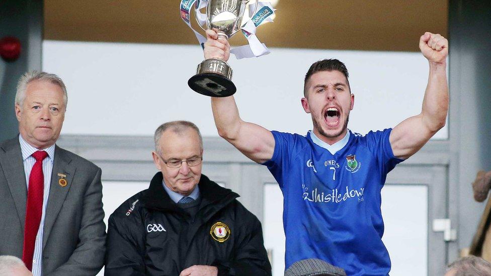 Warrenpoint skipper Ryan Boyle lifts the trophy after the Down side's seven-point success over Inniskeen of Monaghan at the Athletic Grounds