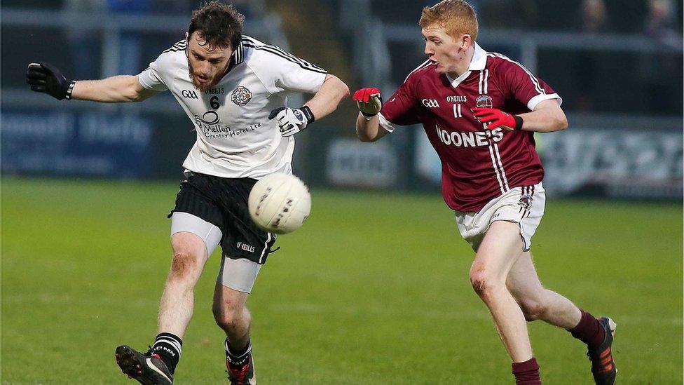 Omagh player Barry Tierney in action against Slaughtneil's Christopher Bradley during the Ulster Club Championship final at the Athletic Grounds