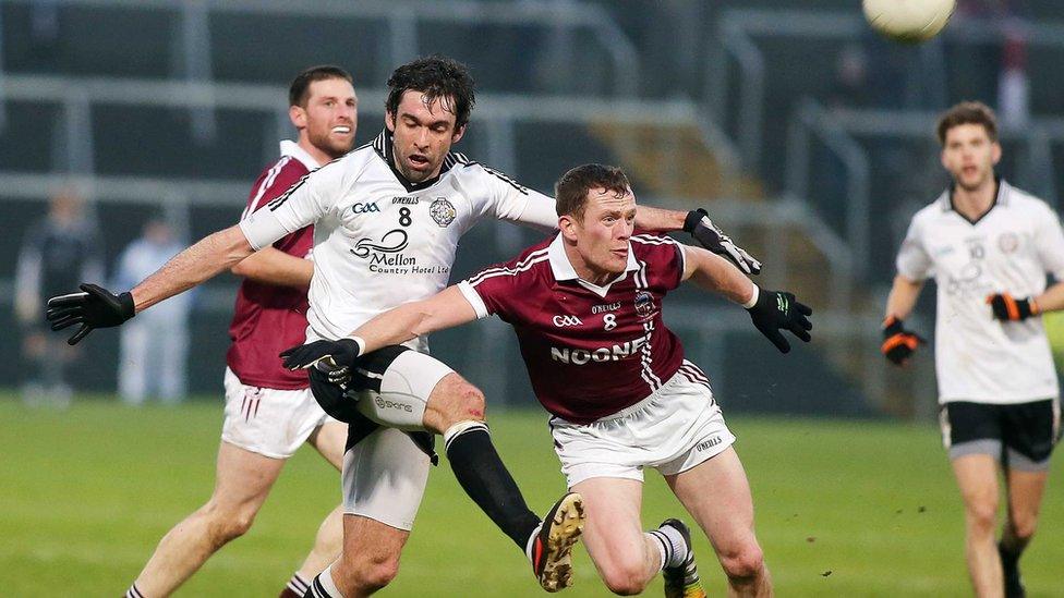 Joe McMahon of Omagh comes under pressure from Slaughtneil's Patsy Bradley