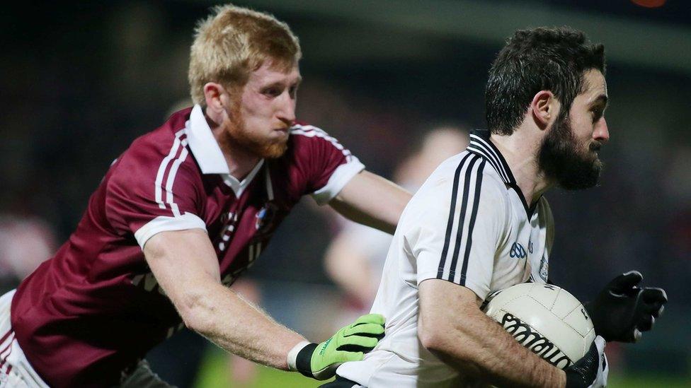 Slaughtneil's Pauldie McGuigan attempts to halt the progress of Omagh player Jason McAnulla during the Ulster club final