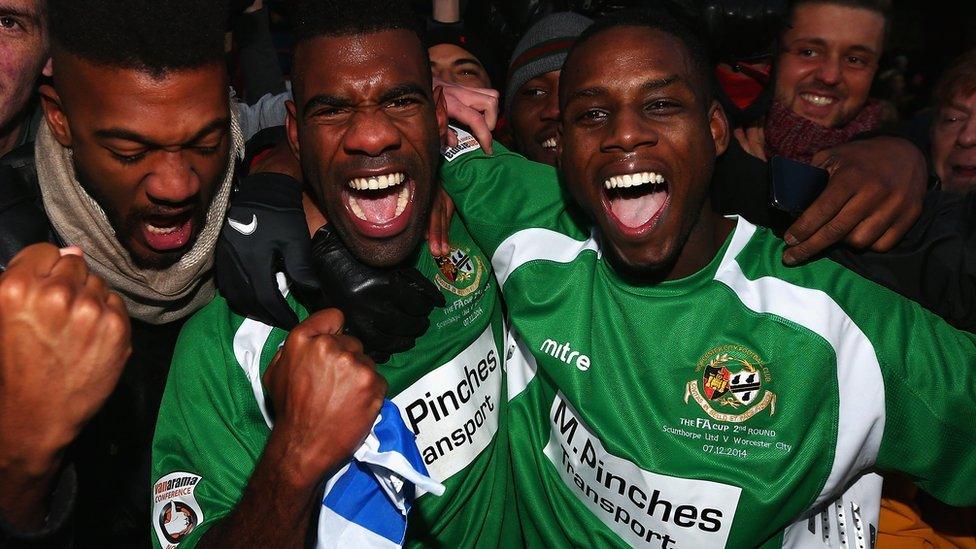 Worcester City players celebrate with fans after their 1-1 draw at Scunthorpe