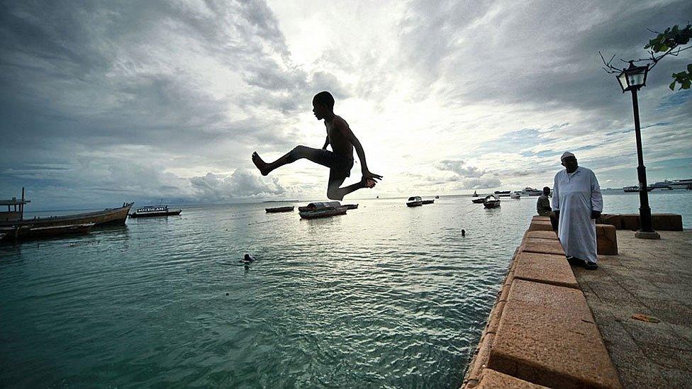 Young man jumping into the sea in Dar es Salam