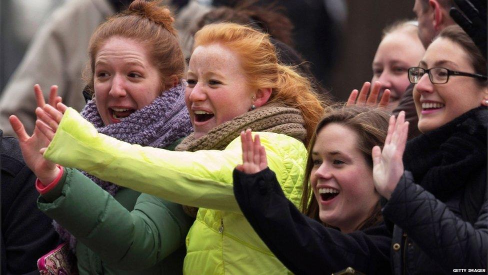 Women waving at Prince William