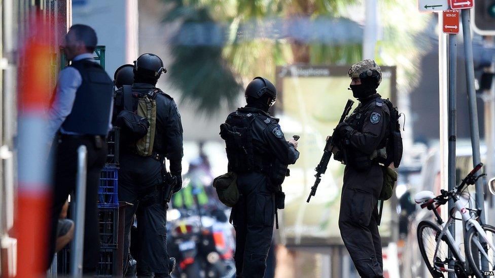 Members of the New South Wales (NSW) Police Force Public Order and Riot Squad (PORS) are seen outside a Lindt cafe in Martin Place in the central business district of Sydney