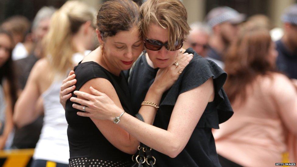 Women comfort each other in Martin Place on December 16, 2014 in Sydney, Australia