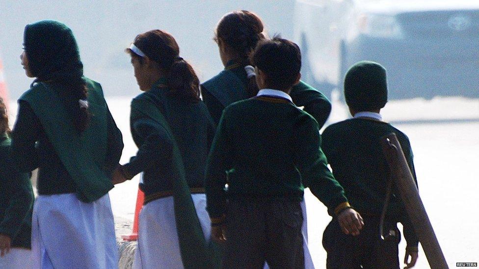 School children fleeing from the scene of an armed incident in Peshawar