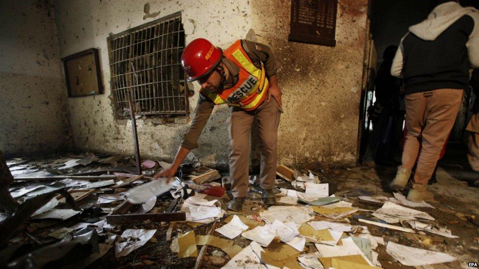 Pakistani security officials inspect the premises of the school that was attacked by Taliban militants in Peshawar - 17 December 2014