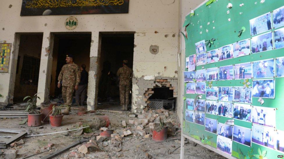 Pakistani soldiers walk amidst the debris in an army-run school a day after an attack by Taliban militants in Peshawar - 17 December 2014