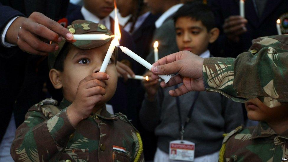 An Indian school child lights candles as they observe two minutes of silence to honour those killed at a Pakistani school - 17 December 2014