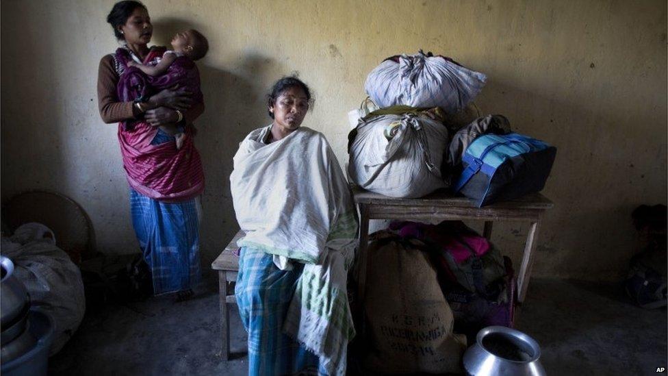 Indian tribal settlers, who fled from their village Phuluguri after an indigenous separatist group attack, take refuge in a local school, in Shamukjuli village in Sonitpur district of Indian eastern state of Assam, Wednesday, Dec. 24, 2014