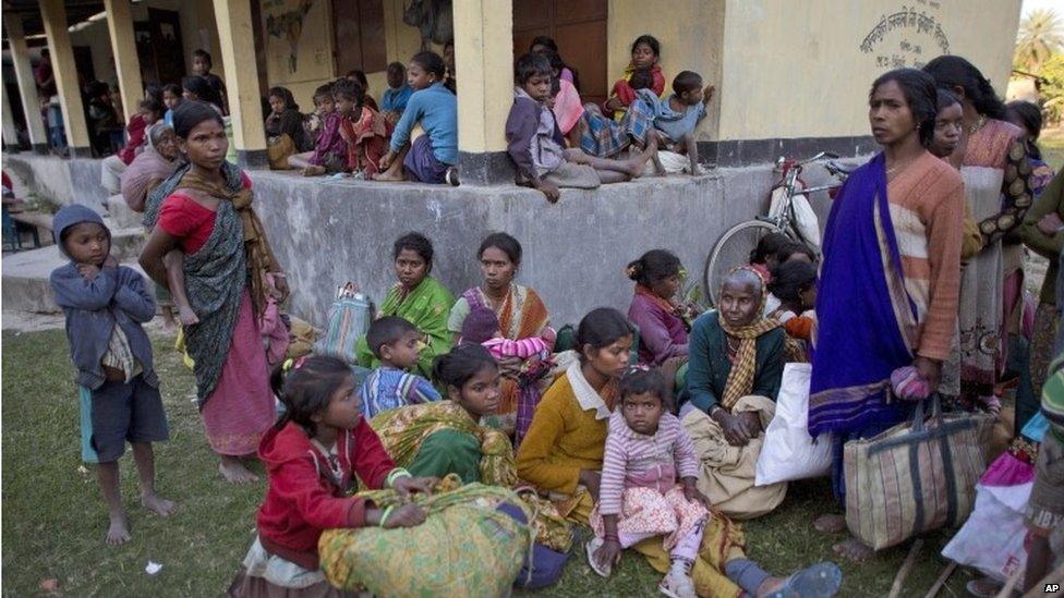 Indian tribal settlers, who fled from their village Phuluguri after an indigenous separatist group attack, take refuge in a local school, in Shamukjuli village in Sonitpur district of Indian eastern state of Assam, Wednesday, Dec. 24, 2014.