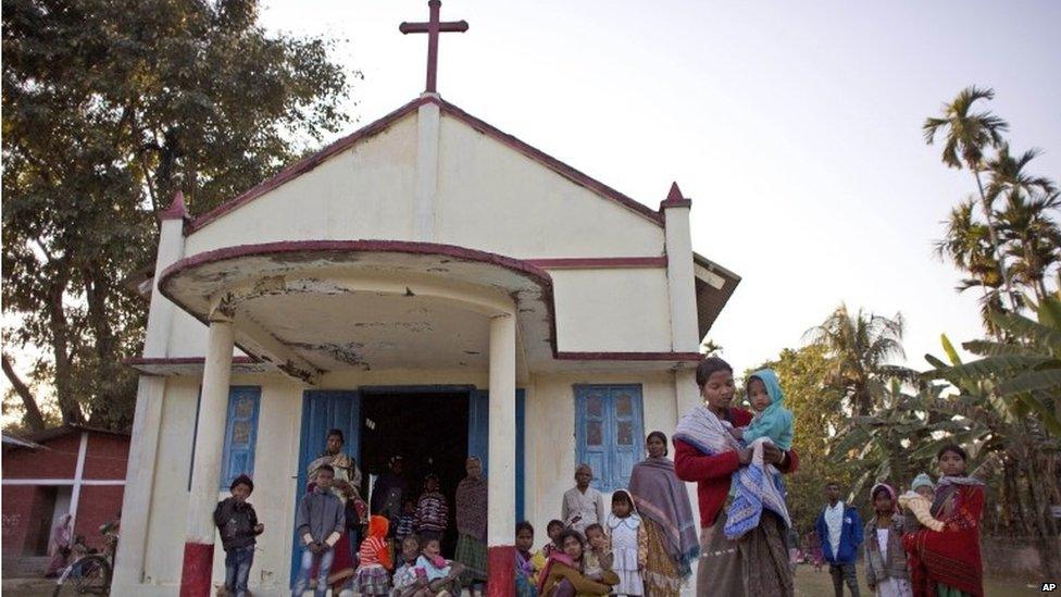 Indian tribal settlers take refuge in a local church after their village was attacked by an indigenous separatist group called the National Democratic Front of Bodoland, in Shamukjuli village in Sonitpur district of Indian eastern state of Assam, Wednesday, Dec. 24, 2014.