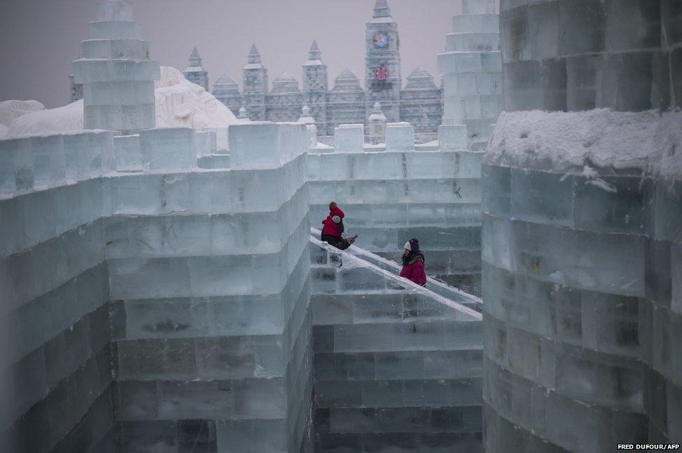 Visitors walks in an ice castle