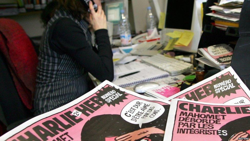 A journalist works in the Paris newsroom of French satirical weekly Charlie Hebdo, in this 2006 file photo.