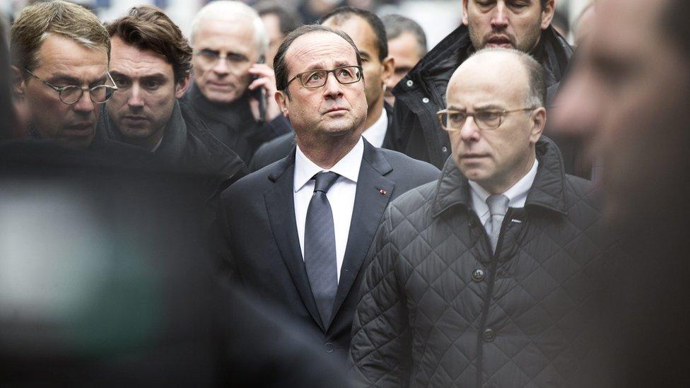 rench President Francois Hollande (C) arrives at the headquarters of the French satirical newspaper Charlie Hebdo in Paris on 7 January 2015