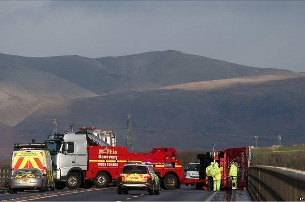 A lorry lies on its side after being blown over in strong winds on the Clackmannanshire Bridge over the Firth of Forth, Scotland, on 10 January