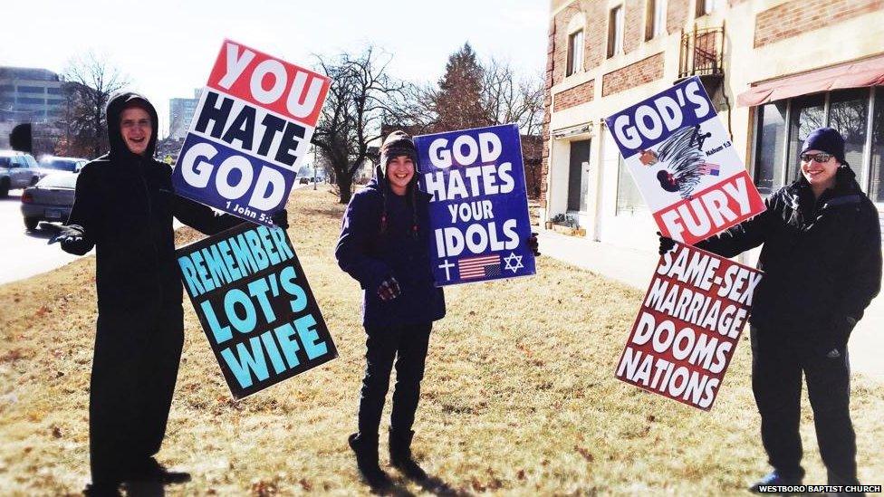 Members of the Westboro Church mount a protest, holding placards