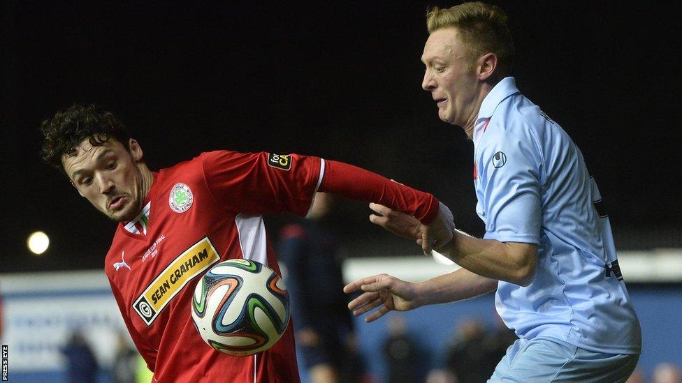 Cliftonville's Tomas Cosgrove in cup final action against Stephen McBride of Ballymena United