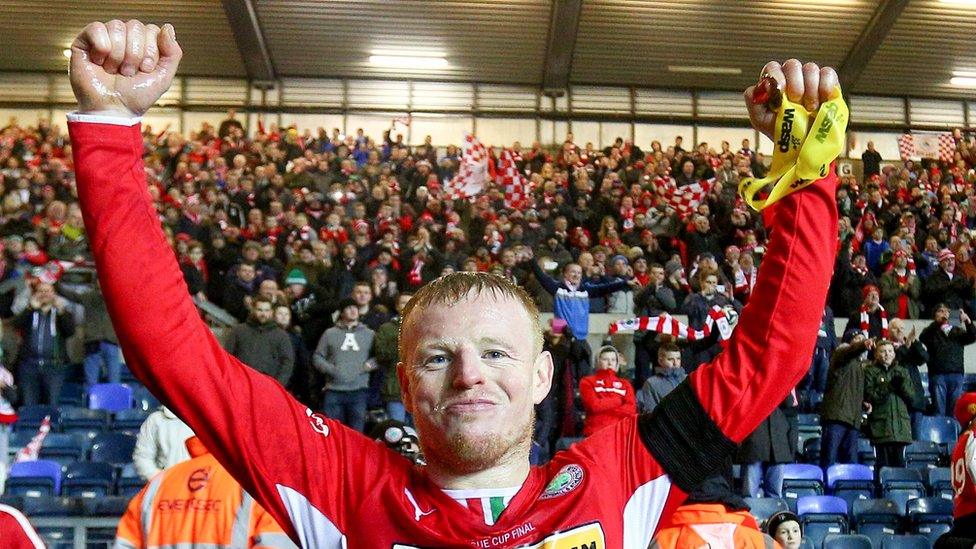 Victorious skipper George McMullan laps up another League Cup triumph after the final at Windsor Park