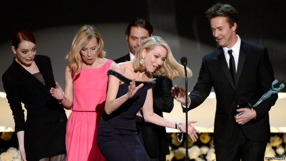 Naomi Watts trips on Emma Stone's dress on stage